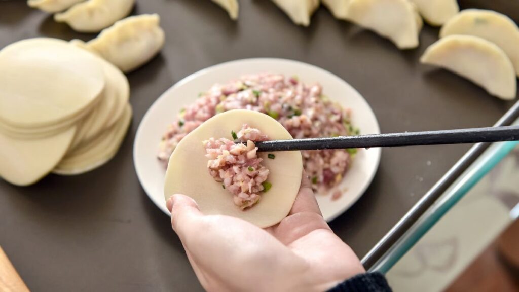 Learn how to make a dumpling in a cooking class in Beijing, China